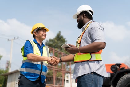 asian-senior-foreman-handshake-with-african-americ-2023-11-27-04-58-08-utc